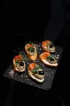 Bruschetta with smoked salmon - Traditional Italian appetizer with smoked salmon, lemon, avocado, and caviar at Moisei restaurant